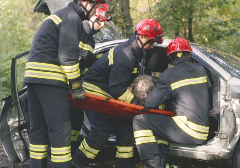 Emergency crews extracting a driver from a wrecked vehicle